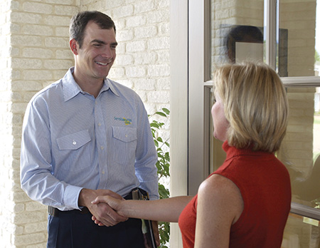 technician shaking hands with woman